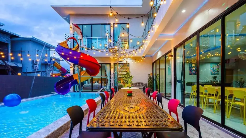 poolside dining table and waterslide at hua hin private pool villa, evening